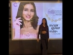 Nancy Tyagi posing against the lightbox that has her poster. Nancy Tyagi posing against the lightbox that has her poster.