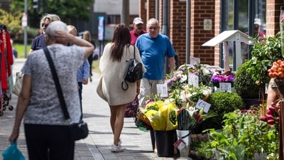 Shoppers pass a flower shop in Strood, UK. Grocery price inflation fell to its lowest level since September 2021 in a further sign of easing cost pressures, ahead of a crucial decision by the Bank of England next month on whether to cut interest rates. (Bloomberg) Shoppers pass a flower shop in Strood, UK. Grocery price inflation fell to its lowest level since September 2021 in a further sign of easing cost pressures, ahead of a crucial decision by the Bank of England next month on whether to cut interest rates. (Bloomberg)