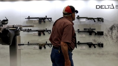 DALLAS, TEXAS - MAY 17: An attendee walks by guns displayed in the Daniel Defense booth during the National Rifle Association (NRA) Annual Meeting & Exhibits at the Kay Bailey Hutchison Convention Center on May 17, 2024 in Dallas, Texas. (Getty Images via AFP) DALLAS, TEXAS - MAY 17: An attendee walks by guns displayed in the Daniel Defense booth during the National Rifle Association (NRA) Annual Meeting & Exhibits at the Kay Bailey Hutchison Convention Center on May 17, 2024 in Dallas, Texas. (Getty Images via AFP)
