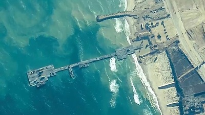FILE - The image provided by U.S, Central Command, shows U.S. Army soldiers assigned to the 7th Transportation Brigade (Expeditionary), U.S. Navy sailors assigned to Amphibious Construction Battalion 1, and Israel Defense Forces placing the Trident Pier on the coast of Gaza Strip on May 16, 2024. (U.S. Central Command via AP)