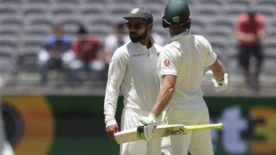 India's Virat Kohli, centre, looks to the umpire after he and opposing captain, Australia's Tim Paine came face to face in Perth. (AP) India's Virat Kohli, centre, looks to the umpire after he and opposing captain, Australia's Tim Paine came face to face in Perth. (AP)
