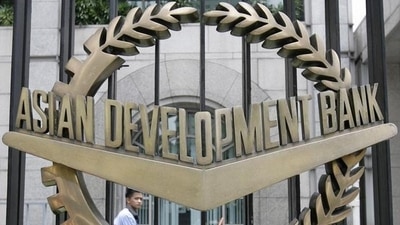 A worker walks past inside the Asian Development Bank (ADB) headquarters in Manila. A worker walks past inside the Asian Development Bank (ADB) headquarters in Manila.