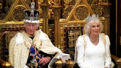 King Charles III looks up as he waits to read the King's Speech, as Queen Camilla sits beside him during the State Opening of Parliament in the House of Lords, London, Wednesday, July 17, 2024. King Charles III's speech will set out the agenda of the UK's first Labour government for 14 years. (AP Photo/Kirsty Wigglesworth, Pool)
