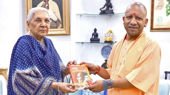 Uttar Pradesh Chief Minister Yogi Adityanath presents the 'Six Golden Pages' book written by Vinayak Damodar Savarkar to State Governor Anandiben Patel during a courtesy call, at Raj Bhavan in Lucknow on Wednesday. (ANI Photo) (Governor of UP-X)