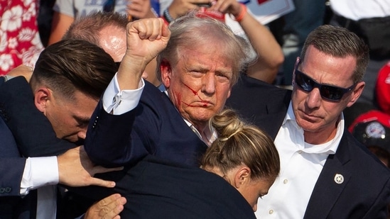 (FILES) Republican candidate Donald Trump is seen with blood on his face surrounded by secret service agents as he is taken off the stage at a campaign event at Butler Farm Show Inc. in Butler, Pennsylvania, July 13, 2024. A Florida judge appointed by Donald Trump has dismissed the criminal case against the former president on charges of mishandling top secret documents, on July 15, 2024 saying the way that Special Counsel Jack Smith was appointed was improper. (Photo by Rebecca DROKE / AFP)(AFP)