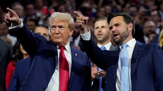 Republican presidential nominee and former U.S. President Donald Trump and Republican vice presidential nominee J.D. Vance point to the stage during Day 1 of the Republican National Convention (RNC) (REUTERS)