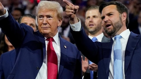 Republican presidential nominee and former US President Donald Trump (left) and Republican vice-presidential nominee JD Vance point to the stage during Day 1 of the Republican National Convention, at the Fiserv Forum in Milwaukee, Wisconsin, US, on Monday. (REUTERS)