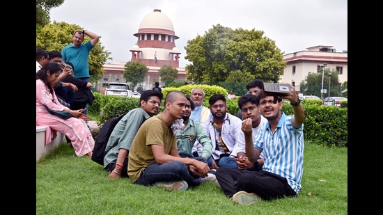 Students wait outside the Supreme Court during the hearing regarding alleged irregularities in NEET-UG 2024. (ANI)