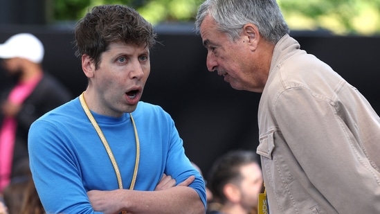 JUNE 10: OpenAI CEO Sam Altman (L) talks with Apple senior Vice President of Services Eddy Cue (R) during the Apple Worldwide Developers Conference (WWDC) on June 10, 2024 in Cupertino, California. (Getty Images via AFP)