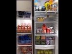 The woman arranged the fridge with various items. The woman arranged the fridge with various items.