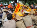 Police personnel stop BJP workers protesting over the alleged scam in the Karnataka Maharshi Valmiki Scheduled Tribes Development Corporation.