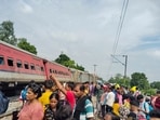 Passengers and locals near the derailed coaches of the Dibrugarh Express train after an accident, in Gonda district. Passengers and locals near the derailed coaches of the Dibrugarh Express train after an accident, in Gonda district.