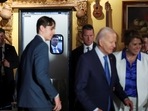 U.S. President Joe Biden greets people, as a Secret Service agent watches through the kitchen door's window, at Lindo Michoacan Mexican Restaurant, in Las Vegas, Nevada.
