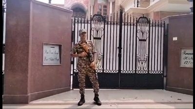 A security person guards outside the residence Congress MLA Rao Dan Singh where ED conducted raids at Sector-17 of Gurugram, on Thursday. (PTI)