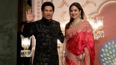 Former Indian cricketer Sachin Tendulkar and wife his Anjali Tendulkar pose for pictures on the red carpet as they attend the blessing ceremony of Anant Ambani and Radhika Merchant. (Reuters)