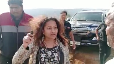 Screen grab from an undated video of IAS probationary officer Puja Khedkar's mother, Manorama, brandishing a small weapon. Screen grab from an undated video of IAS probationary officer Puja Khedkar's mother, Manorama, brandishing a small weapon.