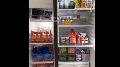 The woman arranged the fridge with various items. The woman arranged the fridge with various items.