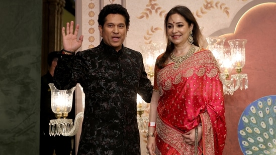 Former Indian cricketer Sachin Tendulkar and wife his Anjali Tendulkar pose for pictures on the red carpet as they attend the blessing ceremony of Anant Ambani and Radhika Merchant.(Reuters)