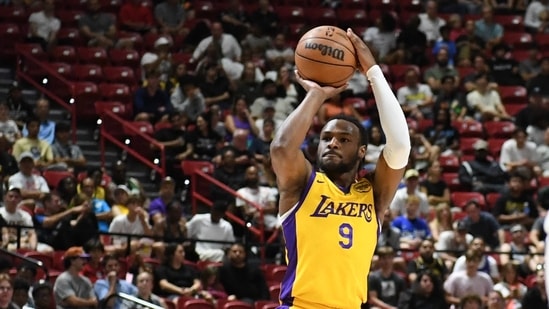 LAS VEGAS, NEVADA - JULY 17: Bronny James Jr. #9 of the Los Angeles Lakers scores on a three-point shot against the Atlanta Hawks in the first half of a 2024 NBA Summer League game at the Thomas & Mack Center on July 17, 2024 in Las Vegas, Nevada. The Lakers defeated the Hawks 87-86. (Getty Images via AFP / Candice Ward)