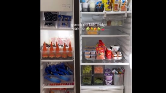 The woman arranged the fridge with various items. 