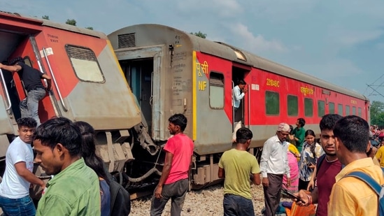 Passengers and locals near the derailed coaches of the Dibrugarh Express train which led to two deaths and 25 injured (PTI Photo) 