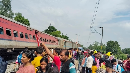Passengers and locals near the derailed coaches of the Dibrugarh Express train after an accident, in Gonda district. (PTI)