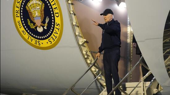 President Joe Biden waves as he walks down the steps of Air Force One at Dover Air Force Base in Delaware, on Wednesday. (AP)