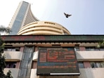A bird flies past a screen displaying the Sensex results on the facade of the Bombay Stock Exchange (BSE) building in Mumbai. (Niharika Kulkarni/Reuters)
