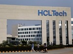 Employees of HCLTech walk inside the office premises on the outskirts of Lucknow, India.(Reuters)