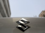 The logo of Maruti Suzuki India Limited is pictured on a car parked outside a showroom in New Delhi, India.