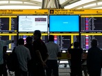 Passengers look at screens, some of them showing Blue Screen errors, at T3 Terminal of the Indira Gandhi International Airport amid Microsoft outage, in New Delhi, Friday, July 19, 2024. Passengers look at screens, some of them showing Blue Screen errors, at T3 Terminal of the Indira Gandhi International Airport amid Microsoft outage, in New Delhi, Friday, July 19, 2024.