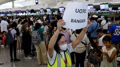 Hong Kong Express Airways passengers queue at counters in Hong Kong International Airport amid system outages disrupting the airline's operations, in Hong Kong. (Reuters)