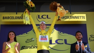 Slovenian rider Tadej Pogacar celebrates on the podium. (AFP)