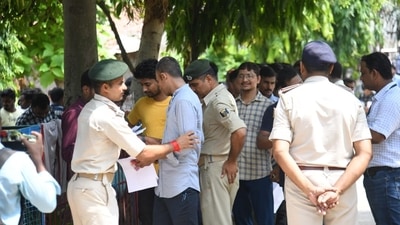 Before entering the examination centre, the candidates were frisked by security personnel stationed outside the centre. (Santosh Kumar) Before entering the examination centre, the candidates were frisked by security personnel stationed outside the centre. (Santosh Kumar)