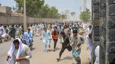 Protesters run as gunfire broke out during a protest rally against the military operation in Pakistan, in Bannu, some 40 kilometres from Afghanistan, on July 19, 2024. (Photo by Karim ULLAH / AFP) (AFP) Protesters run as gunfire broke out during a protest rally against the military operation in Pakistan, in Bannu, some 40 kilometres from Afghanistan, on July 19, 2024. (Photo by Karim ULLAH / AFP) (AFP)