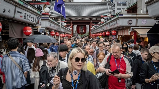 Tourists walking through Nakamise shopping street near Sensoji Temple in Tokyo. Japan welcomed a million more foreign visitors in the first half of 2024 compared to pre-pandemic levels, logging a new record of 17.78 million, the national tourism organisation said on July 19, 2024. Japan eases entry for travellers with new preclearance system, faster immigration processing as tourist wave hits record (Photo by Yuichi YAMAZAKI / AFP)