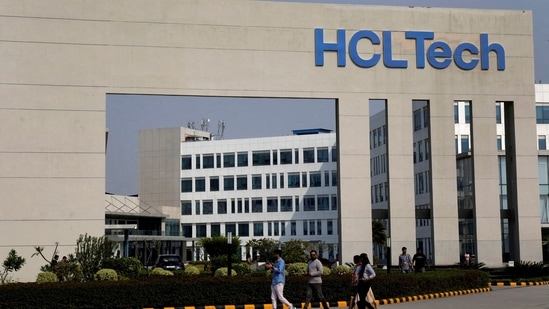 Employees of HCLTech walk inside the office premises on the outskirts of Lucknow, India.(Reuters)