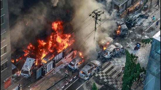 Smoke rises from burning vehicles after protesters set them on fire in Dhaka on Thursday. (AFP Photo)