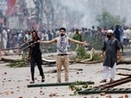 A demonstrator gestures as protesters clash with Border Guard Bangladesh (BGB) and the police outside the state-owned Bangladesh Television as violence erupts across the country after anti-quota protests by students in Dhaka. A demonstrator gestures as protesters clash with Border Guard Bangladesh (BGB) and the police outside the state-owned Bangladesh Television as violence erupts across the country after anti-quota protests by students in Dhaka.