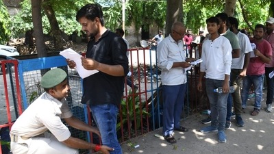 Candidates were frisked by security personnel before they entered the examination hall. (Santosh Kumar) Candidates were frisked by security personnel before they entered the examination hall. (Santosh Kumar)