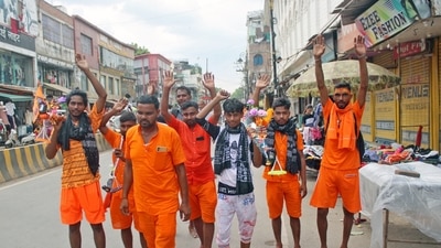 Kanwariyas carrying metal pots filled with water from the River Ganga during their annual Kanwar Yatra, in Varanasi on Friday. (ANI) Kanwariyas carrying metal pots filled with water from the River Ganga during their annual Kanwar Yatra, in Varanasi on Friday. (ANI)