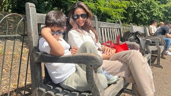 Mira Rajput and her son Zain Kapoor sat on a bench as they posed for the camera. Zain wore a white T-shirt and olive green pants. Mira was seen in a white shirt and beige trousers.