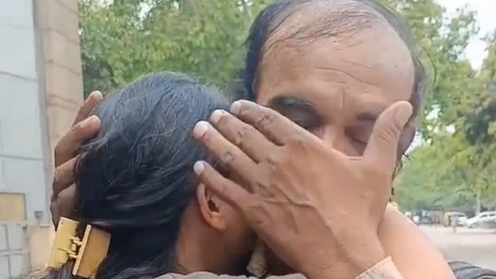 Amita Prajapati with her father as she cries after clearing the CA exam.