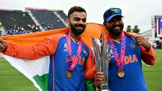 India's Virat Kohli and captain Rohit Sharma celebrate with the trophy after winning the ICC men's Twenty20 World Cup 2024 final(AFP)