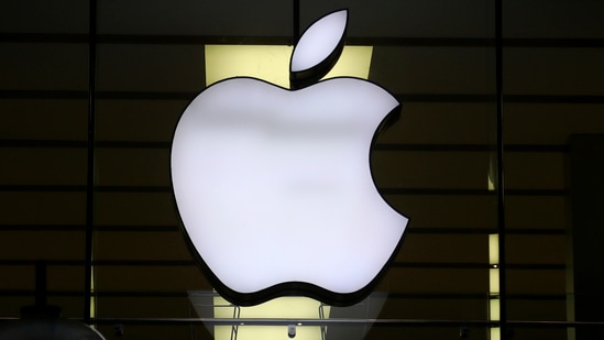 The Apple logo is illuminated at a store in the city center in Munich, Germany.(AP)