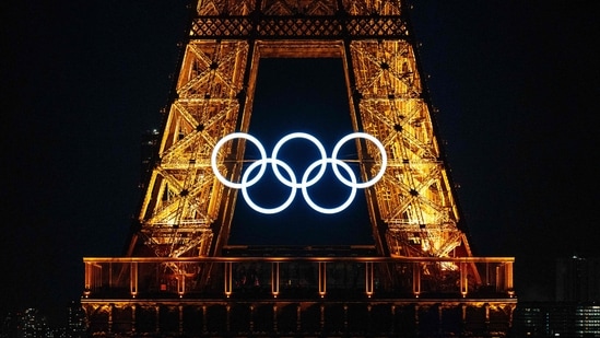 Olympic Rings on the Eiffel Tower ahead of the traditional fireworks marking the annual Bastille Day in Paris.(AFP)