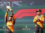 McLaren's Lando Norris celebrates with a trophy on the podium after finishing second place in the Hungarian Grand Prix