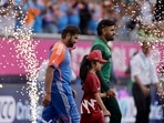 Pakistan's captain Babar Azam, right, and India's captain Rohit Sharma walk into the field. Pakistan's captain Babar Azam, right, and India's captain Rohit Sharma walk into the field.