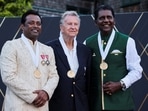 Leander Paes, Richard Evans and Vijay Amritraj pose for a photo after getting inducted into the International Tennis Hall of Fame in Newport.
