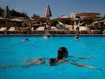 A woman swims in a public swimming pool to cool off in the summer. (AP) A woman swims in a public swimming pool to cool off in the summer. (AP)